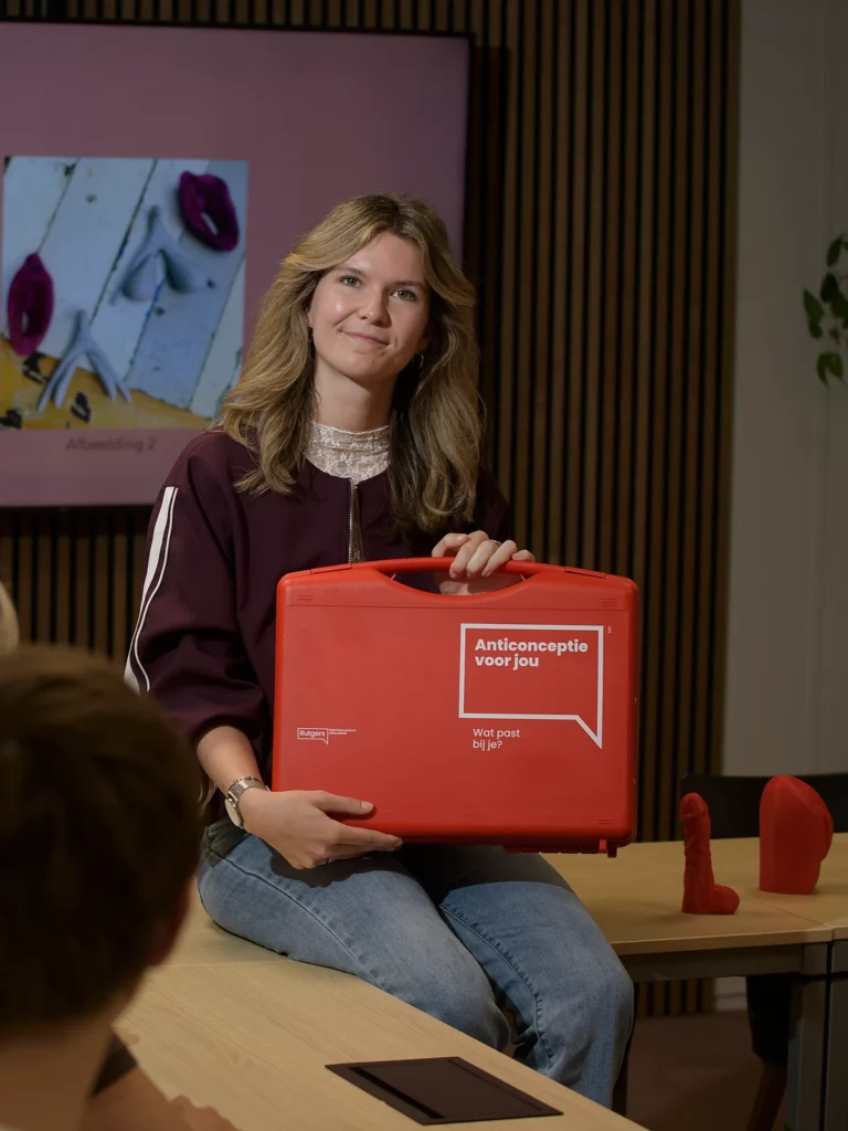 Jasmijn met de anticonceptiekoffer tijdens een les over anatomie